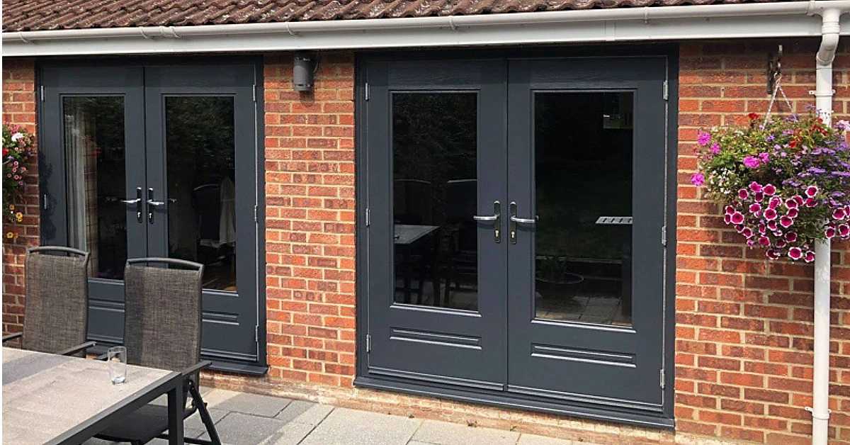More traditional design of composite doors with lower panels with moulding to look more like real wood.